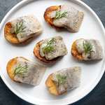 Acme Smoked Fish pickled herring in wine over potatoes
