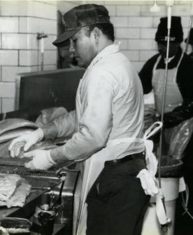 man sorting smoked salmon