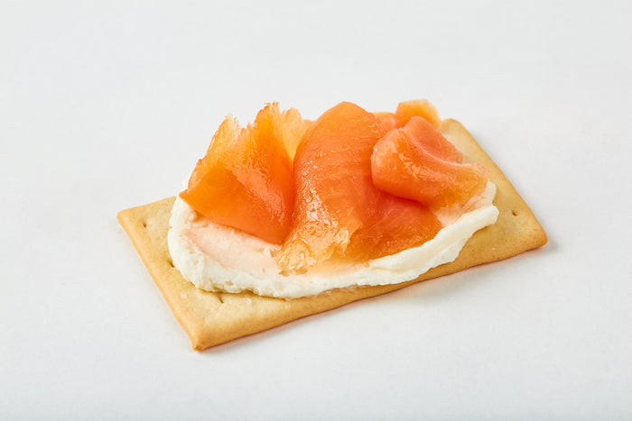 smoked salmon and cream cheese on a cracker
