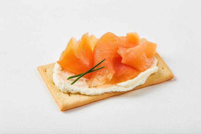 smoked salmon and cream cheese on a cracker