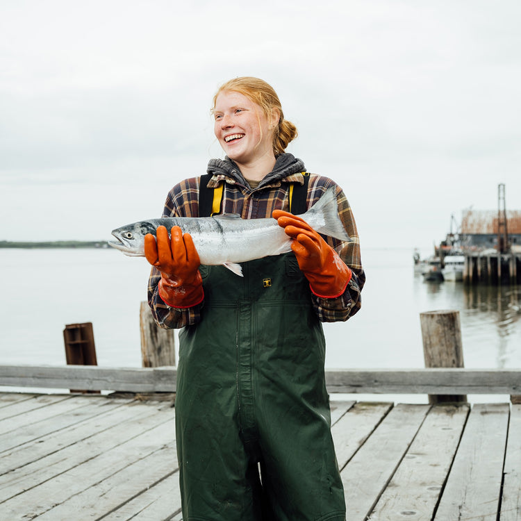 woman holding salmon in Alaska