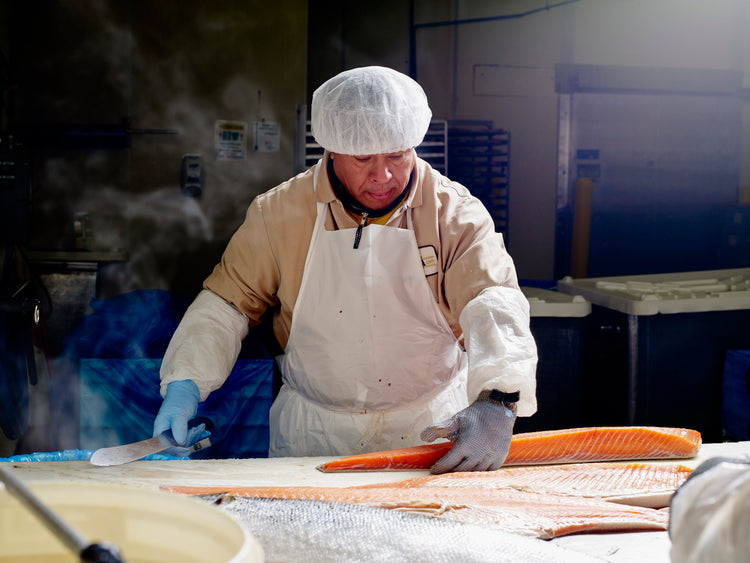 man cutting salmon